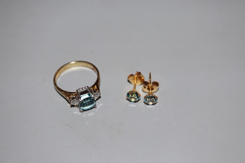 A modern 14k, aquamarine and diamond set three stone ring, size P, gross 3.5 grams & earstuds.